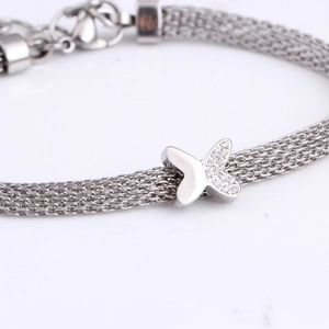 Silver cable chain bracelet with diamond-encrusted butterfly X pendant and woven texture