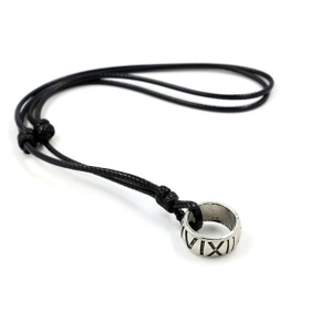 Detail of bohemian necklace with black cord and silver roman numeral ring pendant