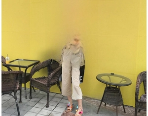 Straw tote bag styled with blue t-shirt and wide-leg linen pants for summer beach look