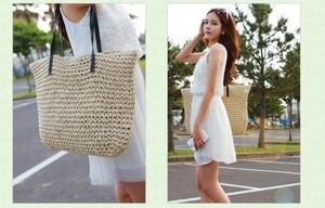 Detail of woven straw tote bag with black leather handles and spacious interior design