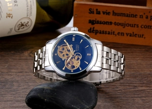 Macro detail of automatic mechanical watch with blue skeleton dial and silver steel band