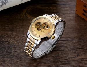 Close-up of golden skeleton dial and dual-tone stainless steel automatic watch movement