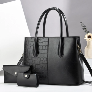 Detailed set of black tote bag and matching pouches with faux crocodile texture finish