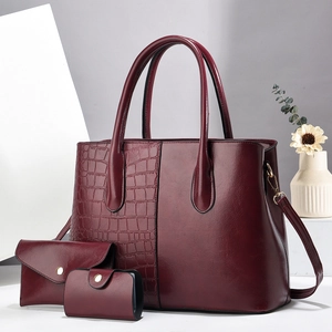 Three-piece burgundy tote bag set with crocodile texture and smooth faux leather finish
