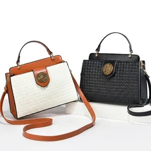 Macro detail of luxury woven leather texture and vintage metal buckle on crossbody bag