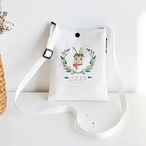 White canvas crossbody bag with lucky rabbit print and adjustable shoulder strap
