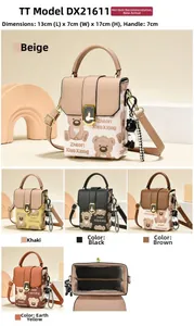 Detailed close-up of a bear pattern canvas crossbody bag with gold-tone hardware and charm