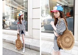 Detailed view of bohemian round straw woven bag with intricate hollow crochet pattern