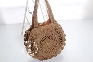 Detailed macro view of the circular woven paper straw beach bag with bohemian wave edge
