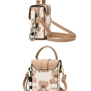 Detail view of mini beige canvas bag with bear print and stylish leather straps