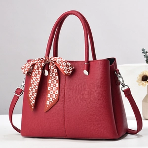 Deep red lychee pattern leather handbag with crossbody strap and silk scarf detail