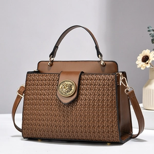 Luxurious dark brown woven handbag with gold buckle and adjustable shoulder strap for women
