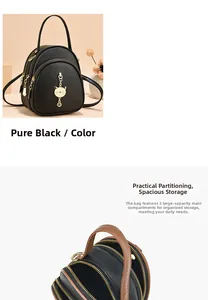 Detail view of the black leather mini backpack with three zipper pockets and cat charm