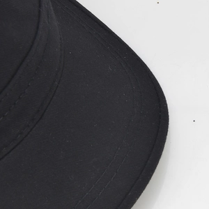 Close-up of black cotton military cap brim with precision double stitching detail