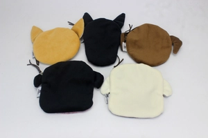 Flat lay view of multiple plush bull terrier coin purses in assorted neutral colors