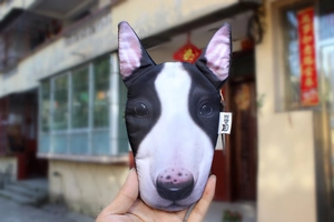 Detailed realistic Bull Terrier dog face printed coin purse held by hand outdoors