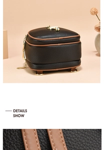 Close-up of black litchi pattern leather with gold hardware and brown trim details