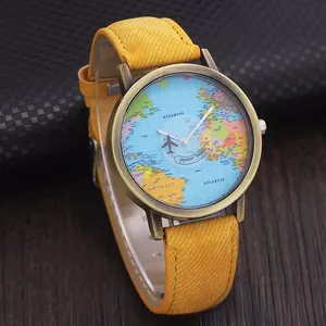 Macro view of denim quartz watch featuring a mini world map dial and airplane second hand