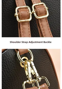 Close-up of adjustable shoulder strap buckle and golden hardware on black mini backpack