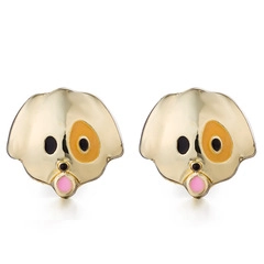 Detail view of cartoon dog stud earrings with colorful enamel finish and golden plating
