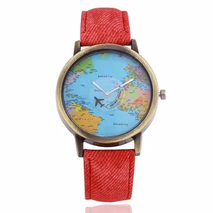 Macro detail of world map dial with airplane hands and red denim fabric watch strap