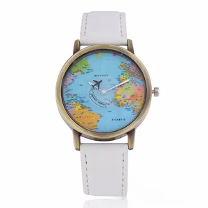 Close-up of vintage bronze watch dial with world map pattern and creative plane pointer