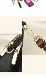 Detail of premium lychee texture leather and golden hardware on the black shoulder bag