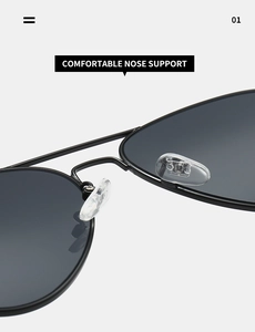 Detail view of adjustable silicone nose pads on black metal pilot sunglasses