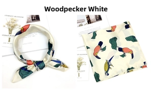 Detail of Toucan White silk scarf showing tropical bird print and styling options
