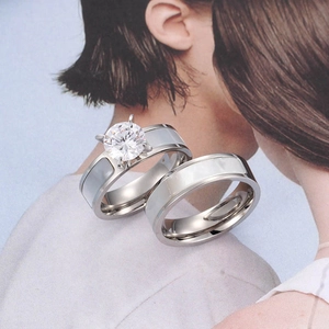 Polished titanium steel couple rings set with shell inlay and a round solitaire diamond