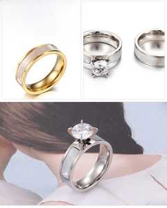Detail of titanium steel couple rings with shell inlay and sparkling cubic zirconia stone