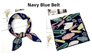Detail of navy blue silk scarf with equestrian belt print and decorative patterns