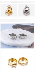 Detail view of titanium couple rings with gold plating and white shell inlay accents