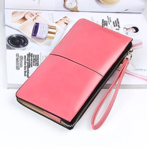 Detailed close-up of rose pink long leather wallet with wristlet and zipper closure