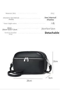 Detail view of the black triple-zipper crossbody bag with litchi grain texture and dimensions
