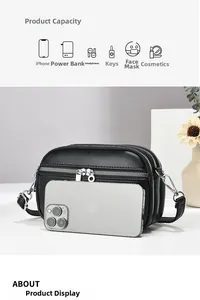 Detail of black pebbled leather crossbody bag with three zipper compartments and high capacity