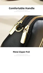 Close-up of black litchi leather texture with premium golden double metal zippers