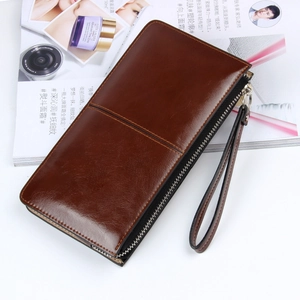 Deep brown leather long wallet featuring decorative cross stitching and wrist strap