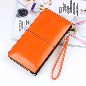Detail of orange oil wax leather long wallet with wristlet strap and silver zipper