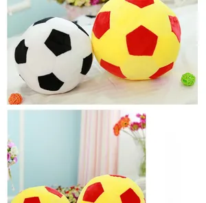Detailed close-up of plush soccer balls in classic black-white and red-yellow color options