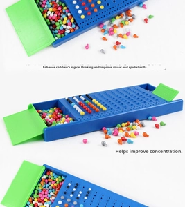 Macro view of blue logical board game base with multi-colored pegs and green storage lids