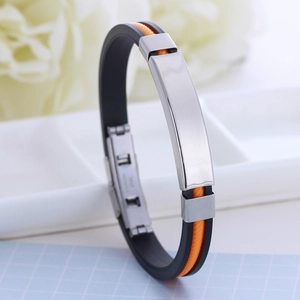 Silicone and stainless steel bracelet with orange and black bands on white tray
