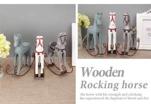 Detailed close-up of three vintage wooden rocking horse figurines with metal wire bases
