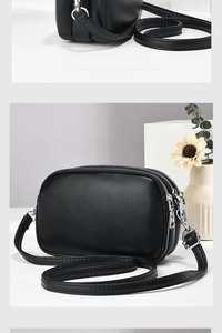 Detail of three independent silver zippers and lychee grain texture on black crossbody bag