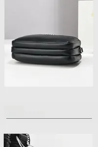 Close-up of black lychee grain leather bag featuring a three-tier silver zipper structure