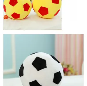 Detailed close-up of plush soccer ball pillows in black-white and yellow-red color schemes