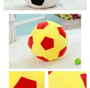 Close-up of yellow and red plush soccer ball toy with soft texture and hexagonal panels