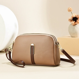 Chic shell-shaped light brown shoulder bag with double zippers and gold hardware