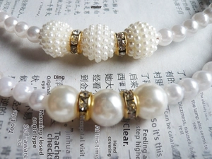 Detail of elegant pearl headbands featuring gold rhinestone spacers and white pearl clusters