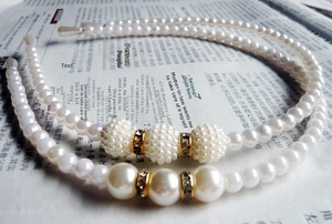 Close-up of pearl headbands with golden diamond-encrusted spacers and white pearls